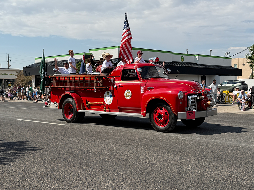 Smokey Bear and his fire patrol, proudly riding aboard a beautifully restored 1950 Howe Fire Engine.