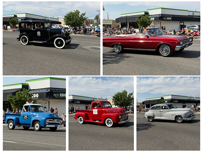 Five different vehicles in the parade oak spokes.